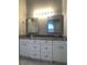Bathroom featuring double vanity with marble countertop and white cabinets at 10969 Norcross Cir, Orlando, FL 32825