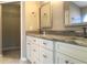 Bathroom featuring double vanity with marble countertop and white cabinets at 10969 Norcross Cir, Orlando, FL 32825