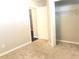 Bedroom featuring soft carpet, access to closet and an open doorway at 10969 Norcross Cir, Orlando, FL 32825