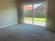 Bedroom featuring neutral paint, carpet, and patio access at 10969 Norcross Cir, Orlando, FL 32825