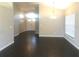Open concept living space with hardwood floors, featuring double door entry and dining area chandelier at 10969 Norcross Cir, Orlando, FL 32825