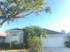 Charming single-story home with a manicured lawn and a two-car garage in a residential neighborhood at 10969 Norcross Cir, Orlando, FL 32825