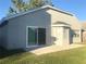 Rear exterior view featuring a sliding glass door and large windows, perfect for natural light at 10969 Norcross Cir, Orlando, FL 32825