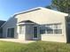 Exterior showcasing a backyard view with sliding glass door and window at 10969 Norcross Cir, Orlando, FL 32825