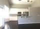 Modern kitchen featuring white cabinets, stainless steel appliances, and marble countertops at 10969 Norcross Cir, Orlando, FL 32825