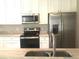 Close-up of a modern kitchen featuring stainless steel appliances and marble countertops at 10969 Norcross Cir, Orlando, FL 32825