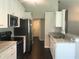 Updated kitchen with stainless steel appliances, granite countertops, and white cabinetry at 10969 Norcross Cir, Orlando, FL 32825
