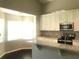 Updated kitchen featuring stone countertops, white cabinetry, and eat in nook with bright natural light at 10969 Norcross Cir, Orlando, FL 32825