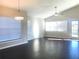 Bright living room features hardwood floors, a ceiling fan, and natural light from large windows at 10969 Norcross Cir, Orlando, FL 32825