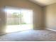 Well-lit living room featuring a sliding glass door that leads to the backyard at 10969 Norcross Cir, Orlando, FL 32825