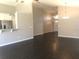 Spacious living area with a view of the kitchen and entry, featuring stylish floors and neutral tones at 10969 Norcross Cir, Orlando, FL 32825