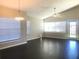 Open living room featuring vaulted ceilings, wood floors and bright, natural light at 10969 Norcross Cir, Orlando, FL 32825