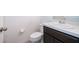 Half bathroom featuring a toilet, vanity, mirror and white walls at 110 Claire Ln, Davenport, FL 33837