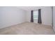 Bright bedroom with plush carpeting, a window for natural light, and neutral walls at 110 Claire Ln, Davenport, FL 33837