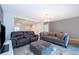 Spacious living room featuring tile floors, gray walls, an area rug, and comfortable seating arrangements at 110 Claire Ln, Davenport, FL 33837