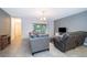 Open-concept living room offering tile floors, sliding door access, and a cozy seating arrangement at 110 Claire Ln, Davenport, FL 33837