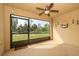 Enclosed sun room with ceiling fan and view of fenced back yard at 110 Claire Ln, Davenport, FL 33837