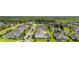 An aerial view of a suburban neighborhood with well-maintained homes and lush green lawns surrounding a pond at 1113 Fieldstone Cir, Oviedo, FL 32765