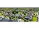 An aerial view of a suburban neighborhood with well-maintained homes and lush green lawns surrounding a pond at 1113 Fieldstone Cir, Oviedo, FL 32765