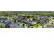 An aerial view of a suburban neighborhood with well-maintained homes and lush green lawns surrounding a pond at 1113 Fieldstone Cir, Oviedo, FL 32765
