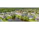 Aerial view of residential neighborhood highlighting lush landscaping and a scenic pond at 1113 Fieldstone Cir, Oviedo, FL 32765