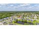 Beautiful aerial view of a suburban neighborhood featuring a pond and lush green trees at 1113 Fieldstone Cir, Oviedo, FL 32765
