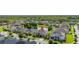An aerial view of a suburban neighborhood with well-maintained homes and lush green lawns surrounding a pond at 1113 Fieldstone Cir, Oviedo, FL 32765