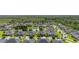 An aerial of a neighborhood features mature trees, sidewalks, manicured lawns, and nearby pond at 1113 Fieldstone Cir, Oviedo, FL 32765