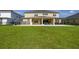 Spacious backyard featuring well-maintained lawn and a covered patio at 1113 Fieldstone Cir, Oviedo, FL 32765