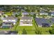 Aerial view displays a backyard with manicured lawn, patio, and landscaping by a tranquil pond at 1113 Fieldstone Cir, Oviedo, FL 32765