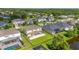 Spacious backyard with a large patio, green lawn, and a beautiful view of the pond at 1113 Fieldstone Cir, Oviedo, FL 32765