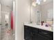 Bathroom vanity with black cabinets, white countertop, and decorative accents at 1113 Fieldstone Cir, Oviedo, FL 32765