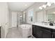 Bright bathroom with a soaking tub, glass shower, double vanity, and stylish fixtures for a spa-like experience at 1113 Fieldstone Cir, Oviedo, FL 32765