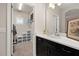 Bright bathroom featuring a vanity with granite countertop and a walk-in closet at 1113 Fieldstone Cir, Oviedo, FL 32765