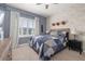 Beautifully decorated bedroom with brick wallpaper, curtains, ceiling fan, and a window with plantation shutters at 1113 Fieldstone Cir, Oviedo, FL 32765