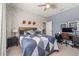 Nicely decorated bedroom with brick wallpaper, a ceiling fan, and a wood-framed bed with a blue quilt at 1113 Fieldstone Cir, Oviedo, FL 32765