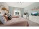 Bedroom with two twin beds, wallpaper accent wall, and ceiling fan at 1113 Fieldstone Cir, Oviedo, FL 32765