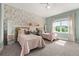 Bedroom featuring two twin beds with wallpaper, ceiling fan, and neutral carpet at 1113 Fieldstone Cir, Oviedo, FL 32765