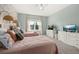 Charming bedroom with twin beds, complemented by whimsical wallpaper, a window view, and matching dressers at 1113 Fieldstone Cir, Oviedo, FL 32765