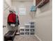 Walk-in closet featuring wire shelving, plastic storage bins, and carpeted floor at 1113 Fieldstone Cir, Oviedo, FL 32765