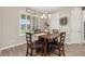Well-lit dining area with a wooden table, four chairs, and a decorative chandelier at 1113 Fieldstone Cir, Oviedo, FL 32765