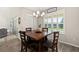 Cozy dining area featuring wood-look floors, plantation shutters, and a stylish chandelier at 1113 Fieldstone Cir, Oviedo, FL 32765