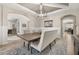 Open-concept dining area boasting a large table, bench seating, modern light fixture, and views into other rooms at 1113 Fieldstone Cir, Oviedo, FL 32765