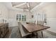 Bright dining room featuring a wooden table, chairs, a modern light fixture, and an entryway at 1113 Fieldstone Cir, Oviedo, FL 32765
