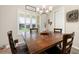 Bright dining room with plantation shutters, modern chandelier, and wood-look flooring at 1113 Fieldstone Cir, Oviedo, FL 32765