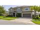 Charming two-story home featuring manicured lawn, a paved driveway, and a two-car garage at 1113 Fieldstone Cir, Oviedo, FL 32765