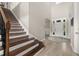 Welcoming foyer with hardwood floors, staircase, and bright front door creating a grand entrance at 1113 Fieldstone Cir, Oviedo, FL 32765