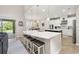 Eat-in kitchen with a large island, bar stool seating, and modern pendant lighting at 1113 Fieldstone Cir, Oviedo, FL 32765