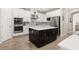 Modern kitchen features stainless steel appliances, an island, and ample counter space at 1113 Fieldstone Cir, Oviedo, FL 32765