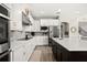 Kitchen with white cabinetry, stainless appliances, and island with breakfast bar at 1113 Fieldstone Cir, Oviedo, FL 32765